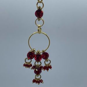 Yellow Gold Tone Pendant With Red Stones